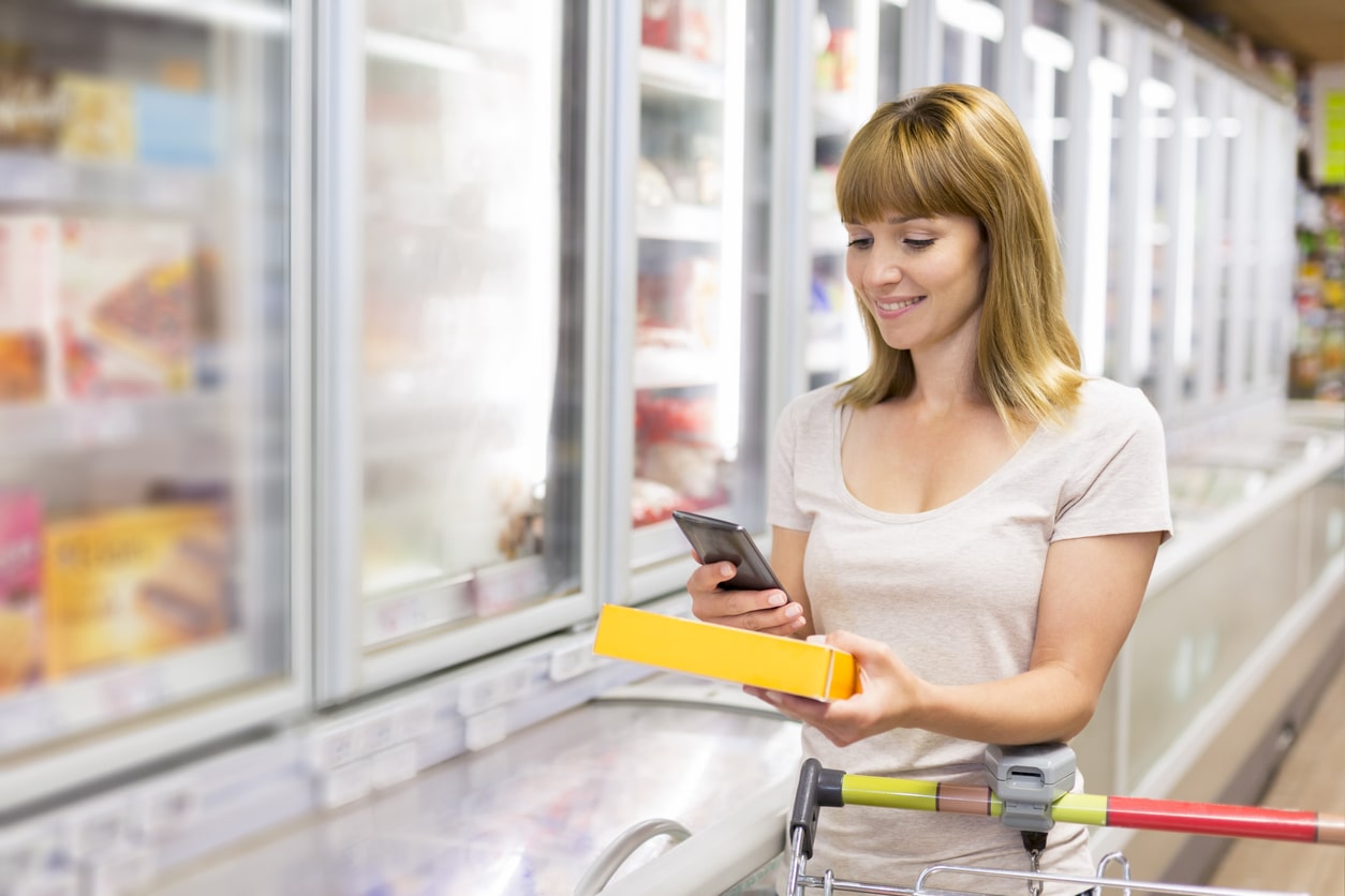 A woman checking gluten free product in supermarket